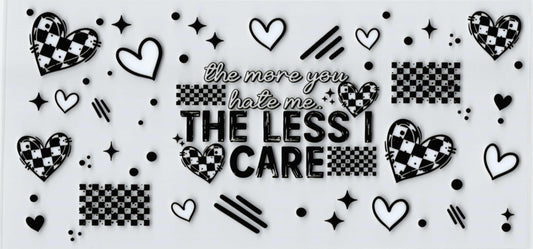 A black and white graphic uvdtf featuring the text 'the more you hate me THE LESS I CARE' surrounded by hearts, stars, stripes, and checkered heart motifs 