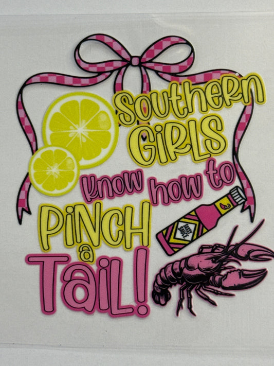 Decorative sticker with text 'Southern girls know how to pinch a tail!' featuring a crawfish, bottle, and lemons.